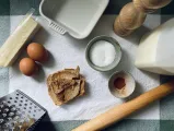 Ingredients for a recipe, including eggs, butter, salt, and some utensils