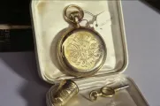 Gold watch with GE initials