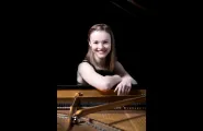 Woman in front of piano