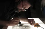 Mark retouching a glass plate photograph