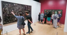 Group in a gallery looking at photographs
